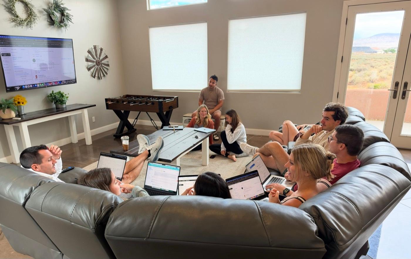 ITG recruiters in an education session on laptops around a sofa