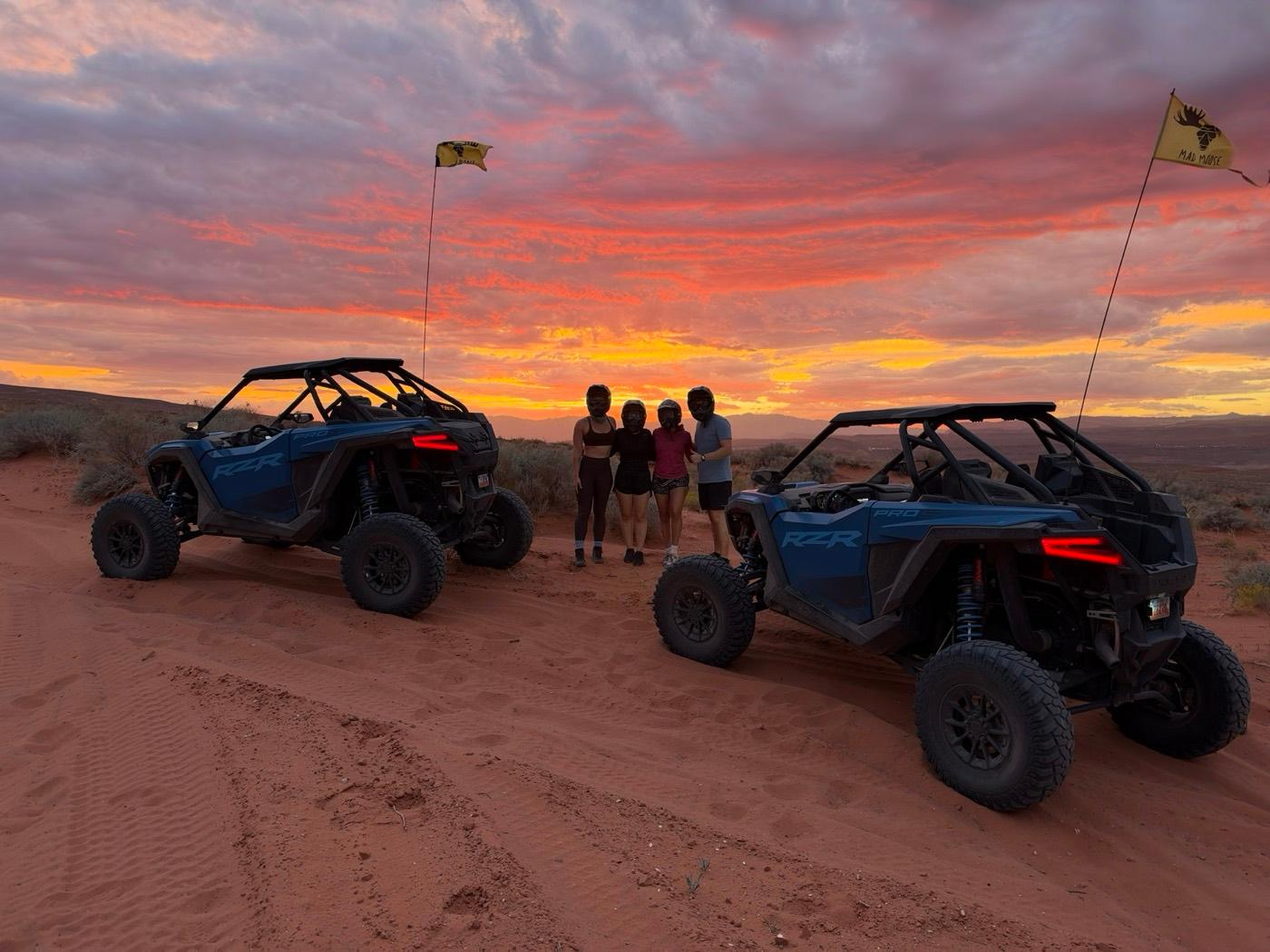 ITG team members with dune buggies at sunset in the Utah desert